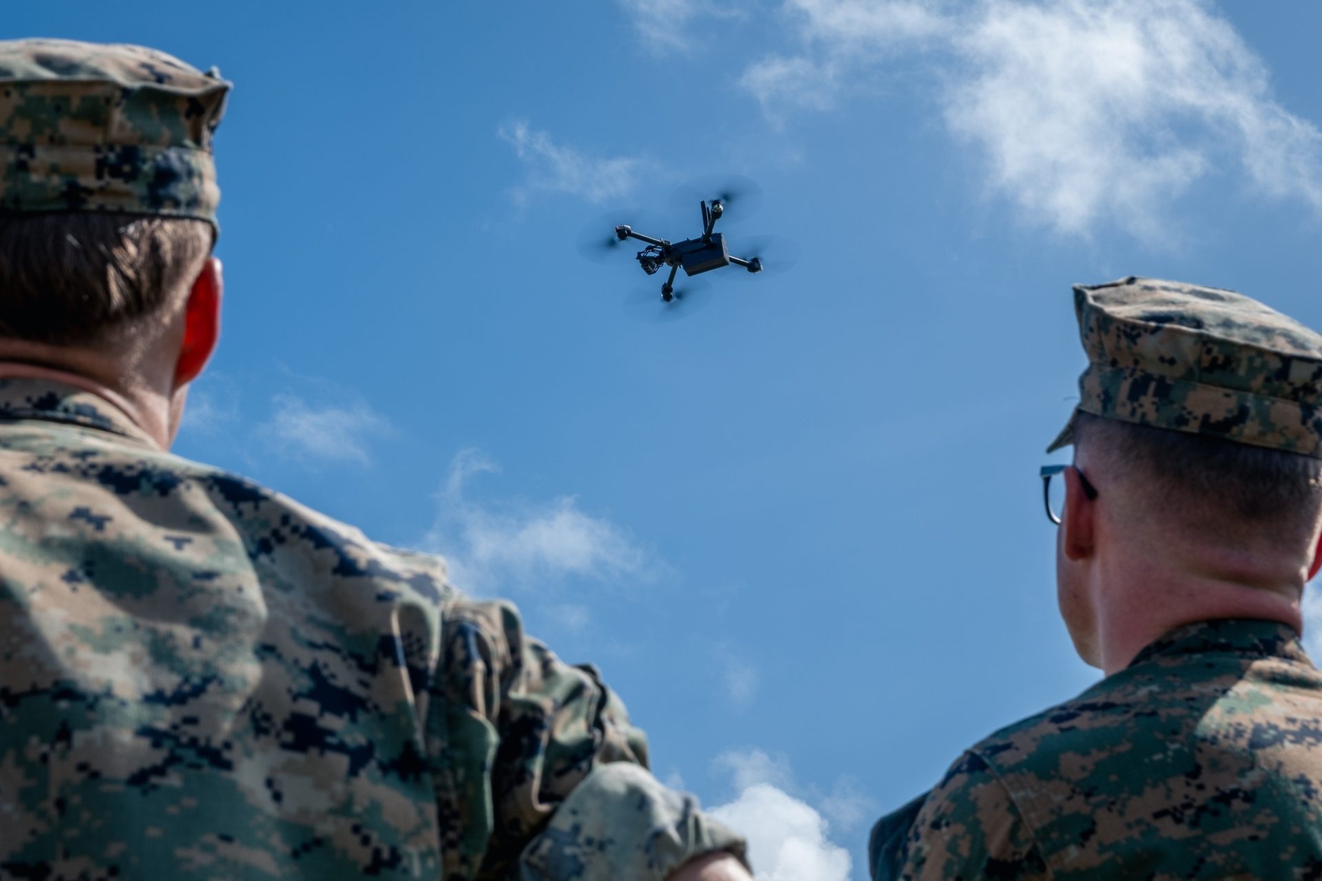 Service members with a small quadcopter overhead