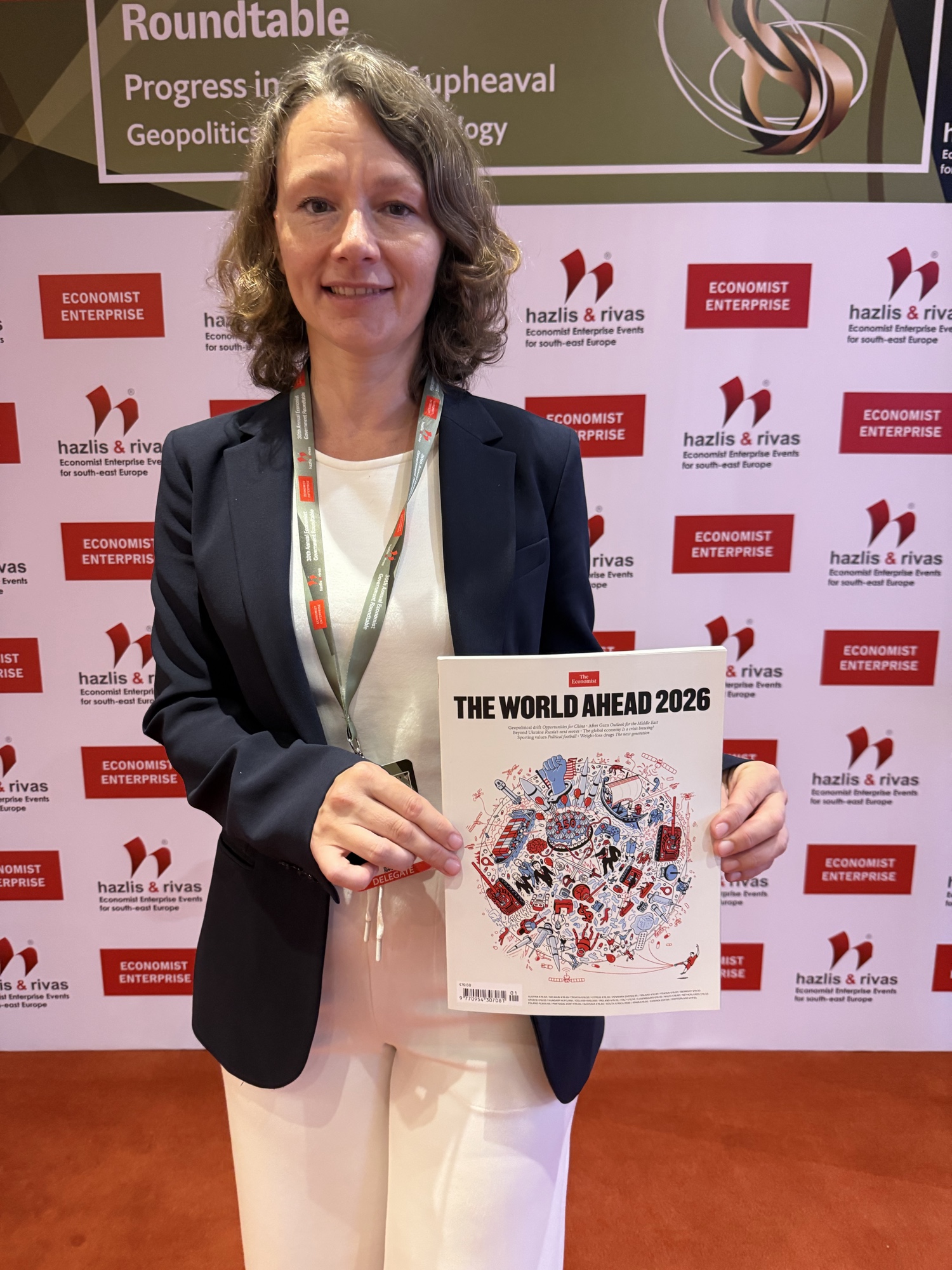 Natalya Meyer, Senior Advisor, Ukraine Partnerships & Defense Technology Transition, on-site at the 30th Annual Government Roundtable, Athens, July 2026, with The Economist&rsquo;s World Ahead 2026 issue.